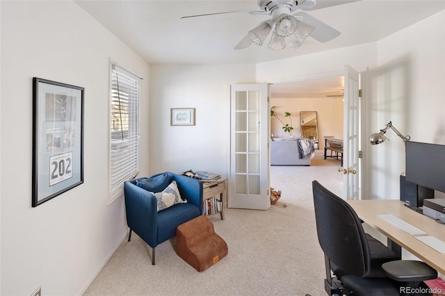 carpeted home office with french doors and ceiling fan