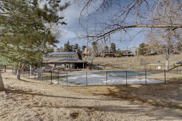 view of yard with fence and a community pool