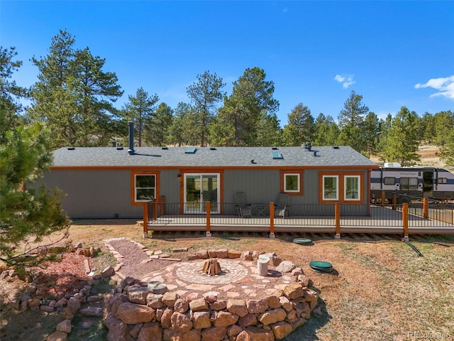109 Forge Dr, Florissant, CO 80816 - rear view of property with an outdoor fire pit and a wooden deck