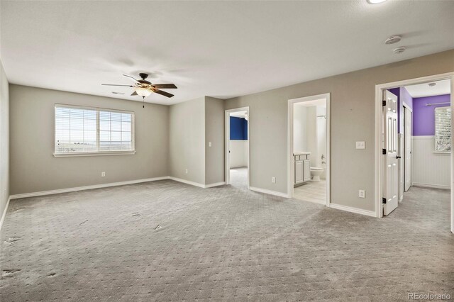 unfurnished room featuring light carpet, ceiling fan, and baseboards