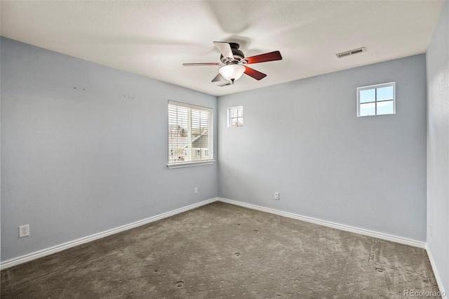 unfurnished room with carpet flooring, visible vents, baseboards, and ceiling fan