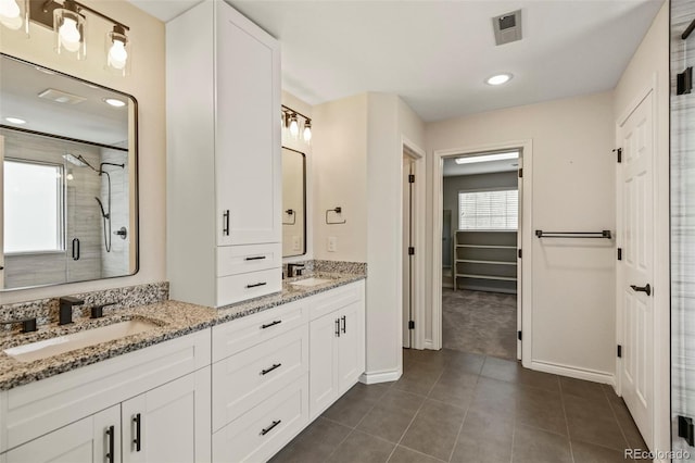 full bath featuring a sink, visible vents, tile patterned floors, and a stall shower