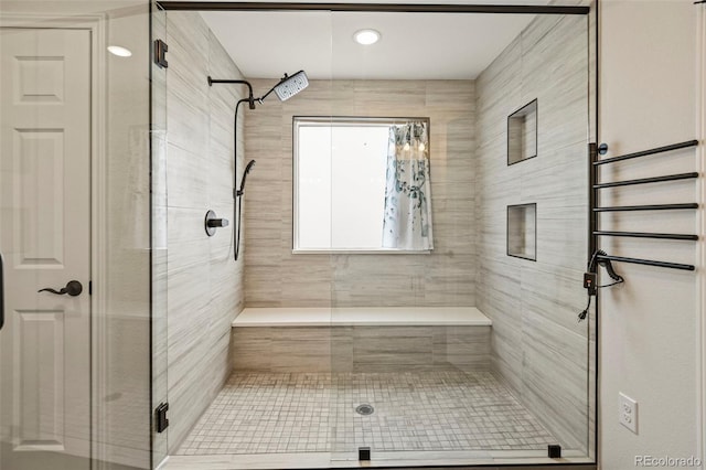 bathroom with a shower stall and tile patterned floors