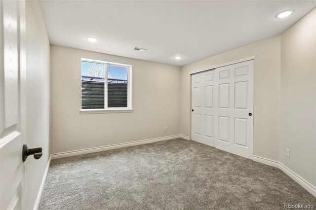 unfurnished bedroom featuring recessed lighting, baseboards, visible vents, and carpet floors