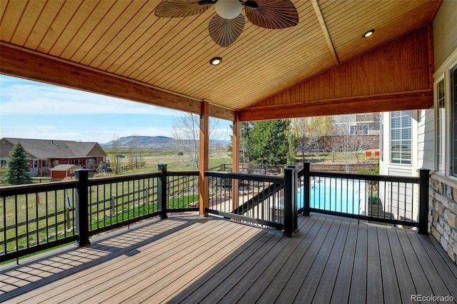 wooden deck with a mountain view and a ceiling fan