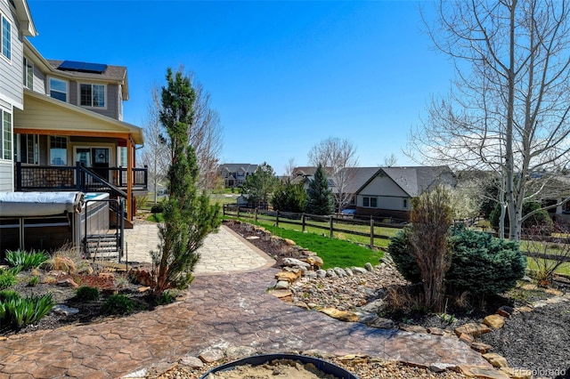 view of yard featuring a residential view, fence, and a patio