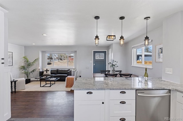 kitchen featuring light stone counters, dark wood-style flooring, a peninsula, white cabinetry, and stainless steel dishwasher