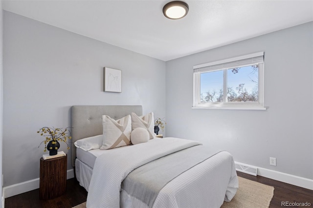 bedroom featuring dark wood-style flooring, visible vents, and baseboards