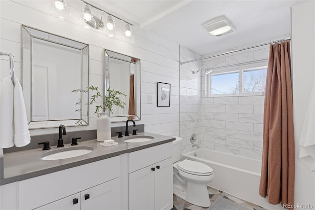 full bath with a sink, shower / bathtub combination with curtain, toilet, and double vanity