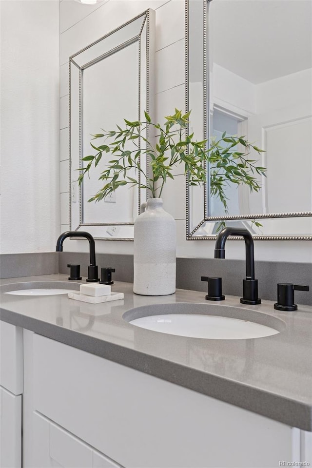 full bathroom featuring a sink and double vanity