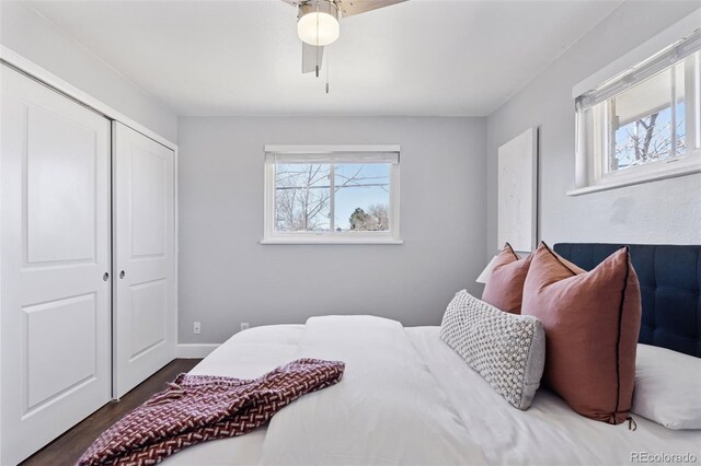 bedroom featuring a closet, ceiling fan, baseboards, and wood finished floors