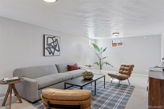 carpeted living area featuring baseboards