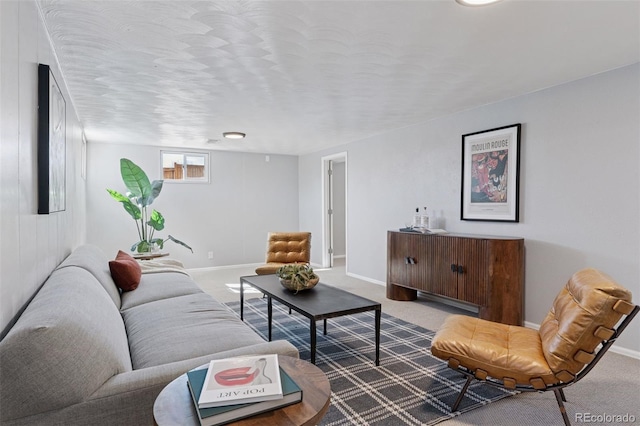 carpeted living room featuring baseboards