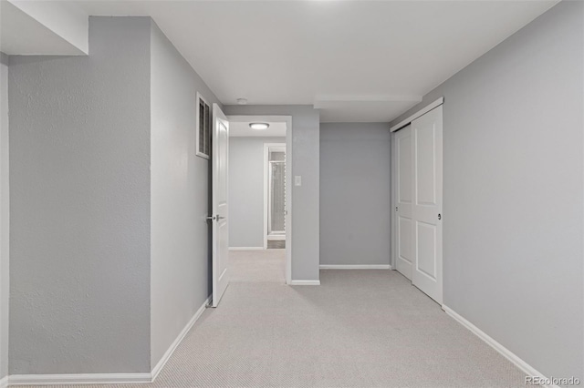 corridor featuring carpet floors and baseboards