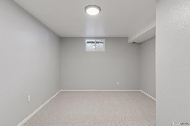 basement with baseboards and carpet flooring