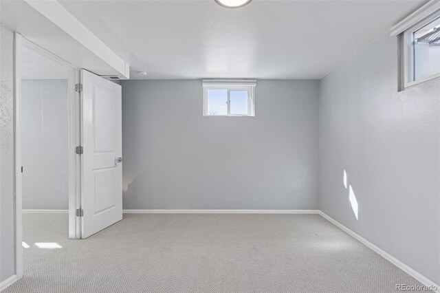 basement featuring carpet flooring and baseboards