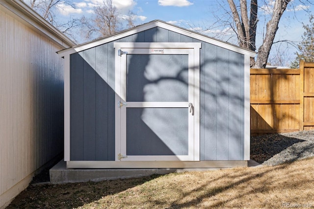 view of shed featuring fence