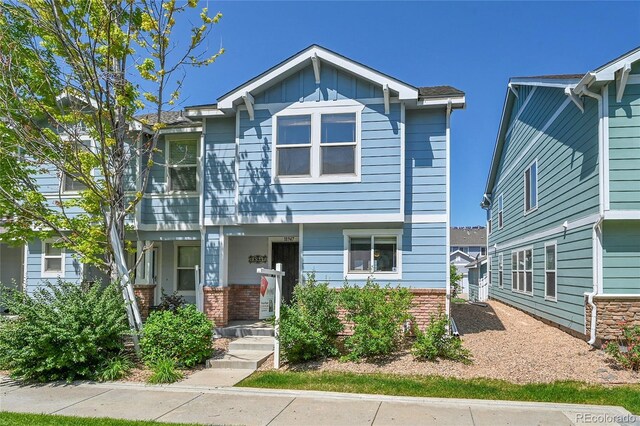 18947 E 57th Pl, Denver, CO 80249 - view of front facade featuring brick siding and board and batten siding