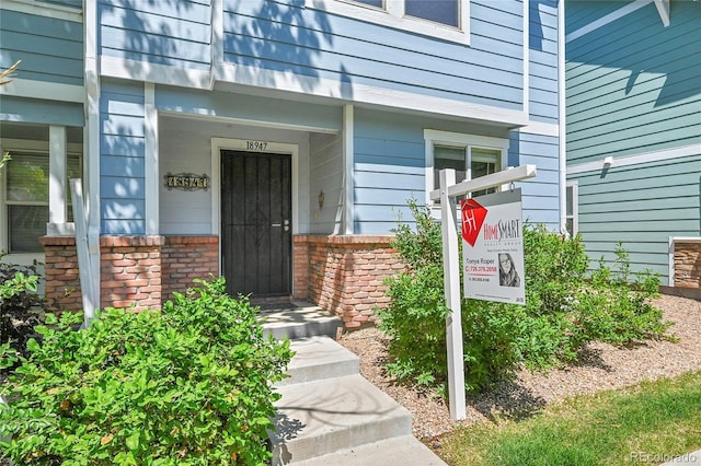 18947 E 57th Pl, Denver, CO 80249 - view of exterior entry with brick siding