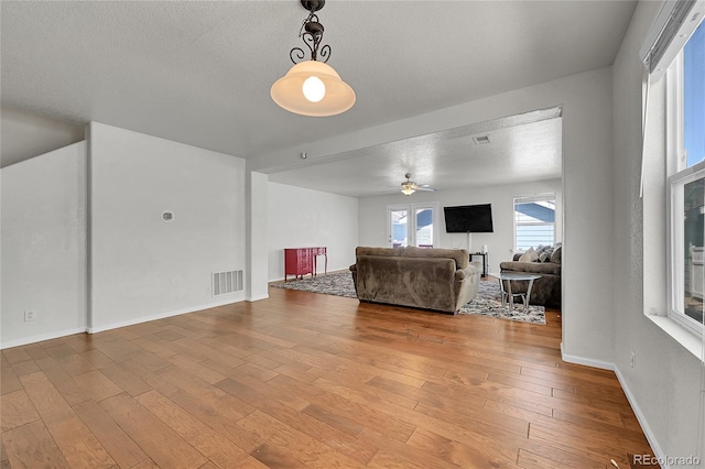 18947 E 57th Pl, Denver, CO 80249 - living room with a ceiling fan, hardwood / wood-style flooring, and a textured ceiling