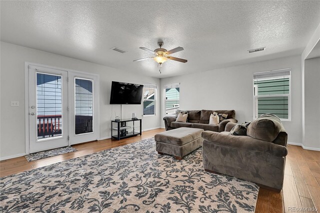 18947 E 57th Pl, Denver, CO 80249 - living area with wood finished floors, a textured ceiling, and ceiling fan