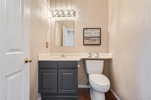 bathroom featuring hardwood / wood-style flooring, vanity, and toilet