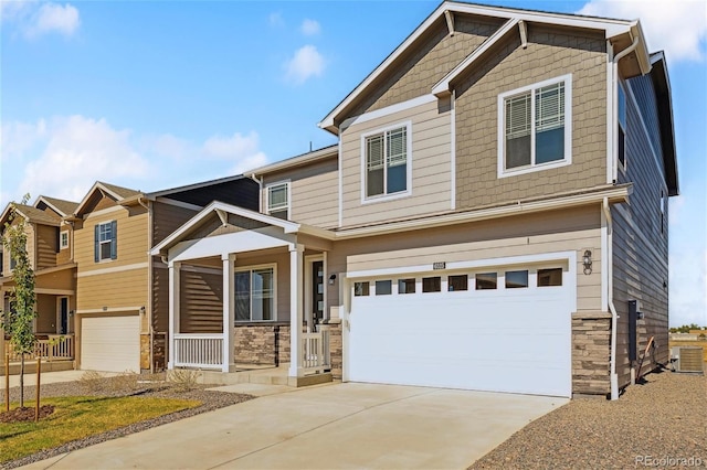 27424 E Byers Ave, Aurora, CO 80018 - craftsman house with stone siding, a garage, a porch, and driveway