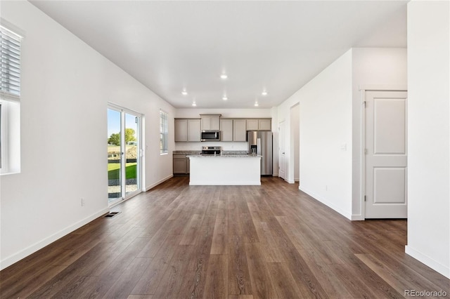 27424 E Byers Ave, Aurora, CO 80018 - unfurnished living room with dark wood-style floors and recessed lighting