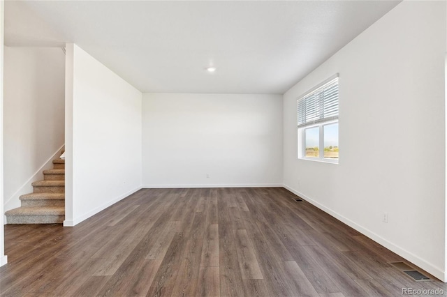 27424 E Byers Ave, Aurora, CO 80018 - unfurnished room featuring stairway and dark wood-style floors
