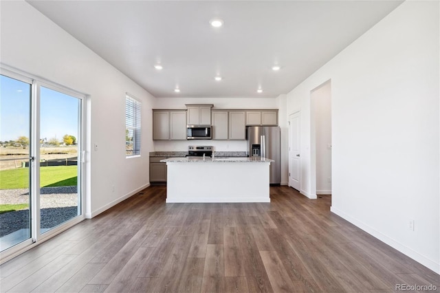 27424 E Byers Ave, Aurora, CO 80018 - kitchen with appliances with stainless steel finishes, a kitchen island, dark wood-style flooring, gray cabinets, and recessed lighting
