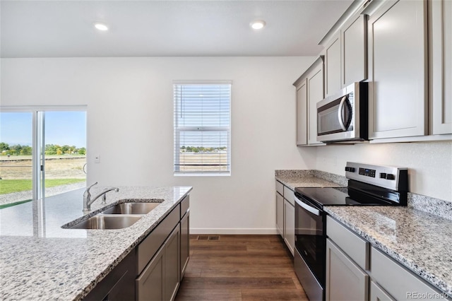 27424 E Byers Ave, Aurora, CO 80018 - kitchen featuring appliances with stainless steel finishes, plenty of natural light, dark wood-type flooring, gray cabinetry, and recessed lighting
