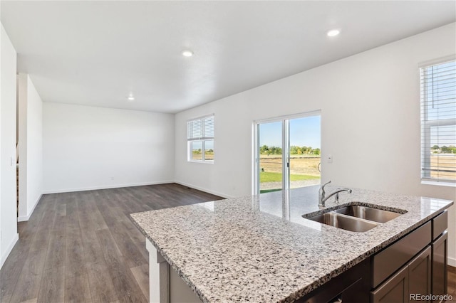 27424 E Byers Ave, Aurora, CO 80018 - kitchen with a kitchen island with sink, dark wood-type flooring, light stone counters, recessed lighting, and open floor plan