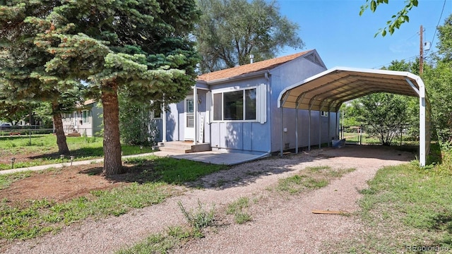 1930 S Prospect Ave, Colorado Springs, CO 80905 - view of front facade with a detached carport and dirt driveway