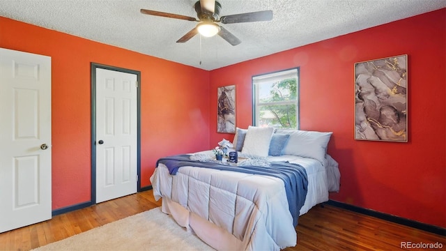 1930 S Prospect Ave, Colorado Springs, CO 80905 - bedroom featuring wood finished floors, a textured ceiling, ceiling fan, and baseboards