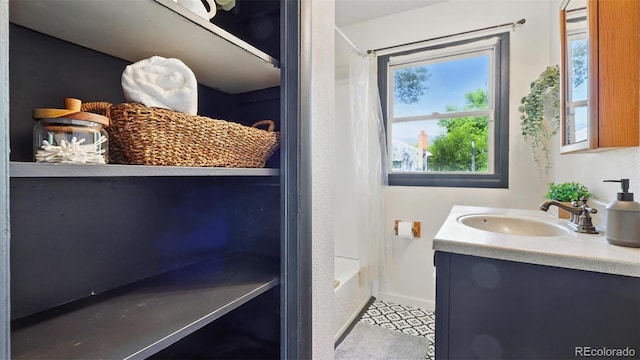 1930 S Prospect Ave, Colorado Springs, CO 80905 - full bathroom featuring vanity, baseboards, and shower / bath combo with shower curtain