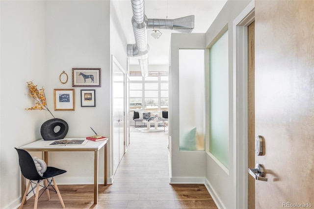 corridor featuring wood-type flooring