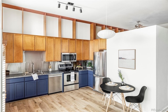 kitchen featuring sink, light hardwood / wood-style flooring, ceiling fan, decorative light fixtures, and stainless steel appliances