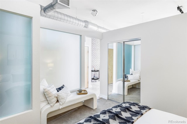 carpeted bedroom with a closet