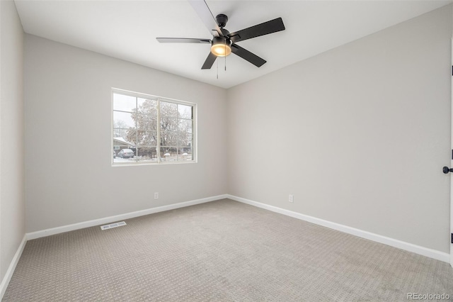 carpeted empty room featuring baseboards, a ceiling fan, and visible vents