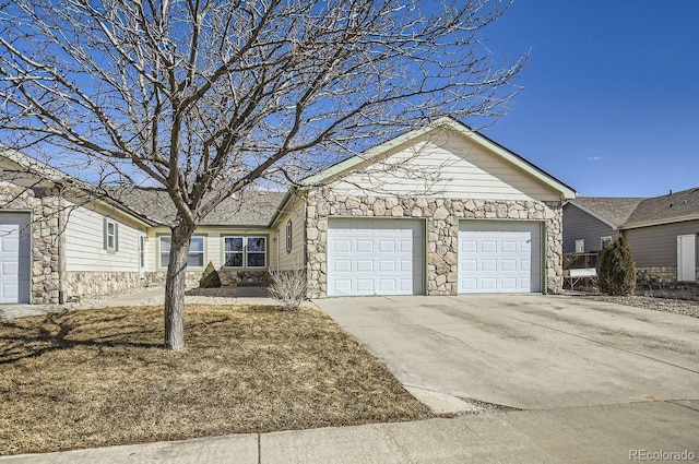 ranch-style house featuring stone siding, an attached garage, and concrete driveway