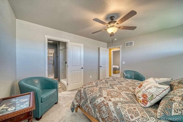 carpeted bedroom featuring a textured ceiling and ceiling fan