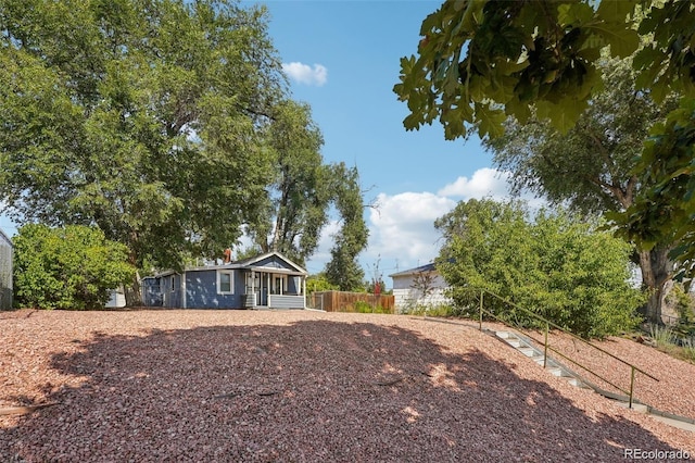 ranch-style house featuring fence