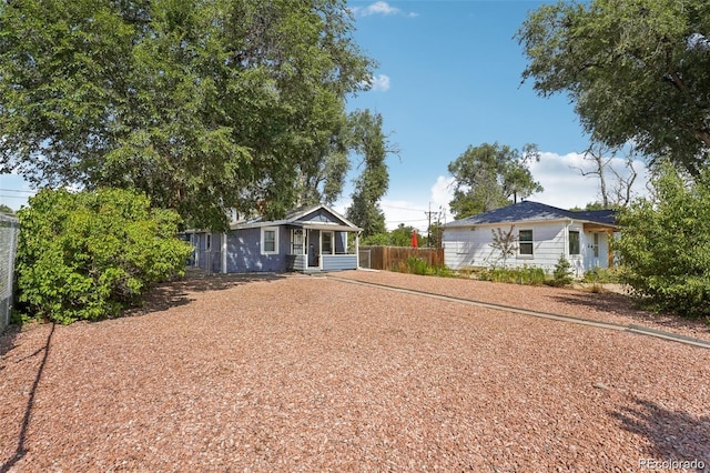 ranch-style home featuring fence