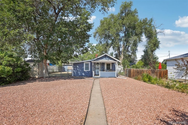 bungalow-style home featuring fence