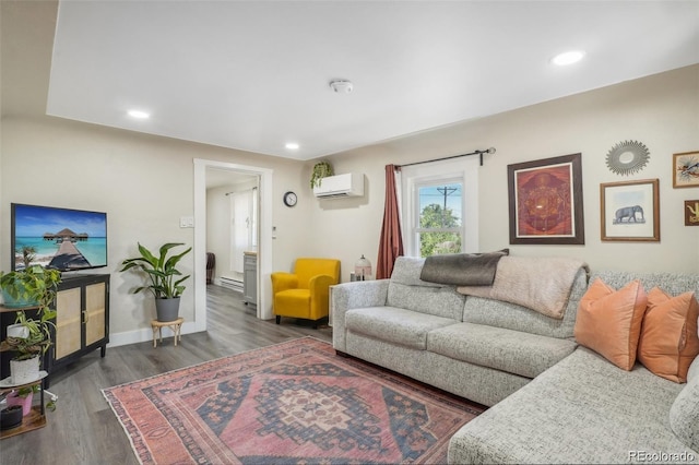 living area with a wall unit AC, baseboards, wood finished floors, and recessed lighting