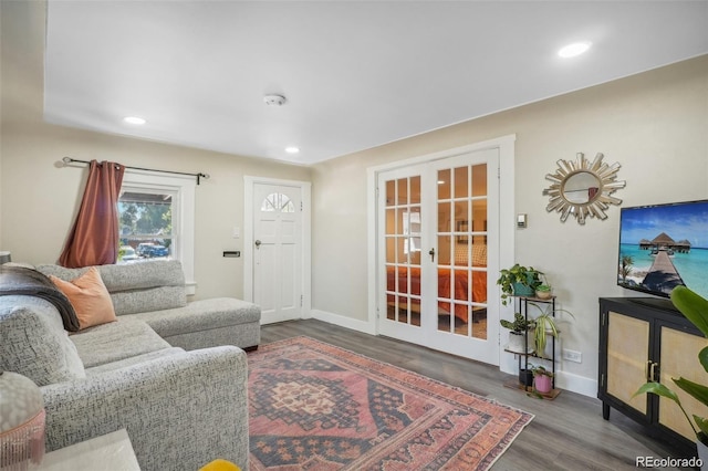 living area featuring recessed lighting, baseboards, wood finished floors, and french doors