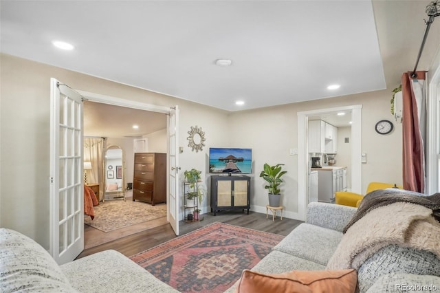 living room with baseboards, wood finished floors, and recessed lighting