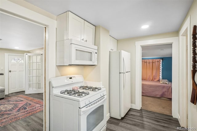 kitchen featuring white appliances, baseboards, white cabinets, dark wood-style flooring, and recessed lighting