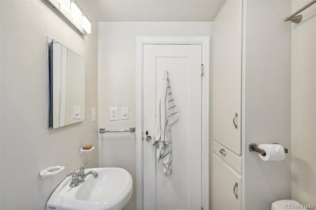 bathroom featuring toilet and a sink