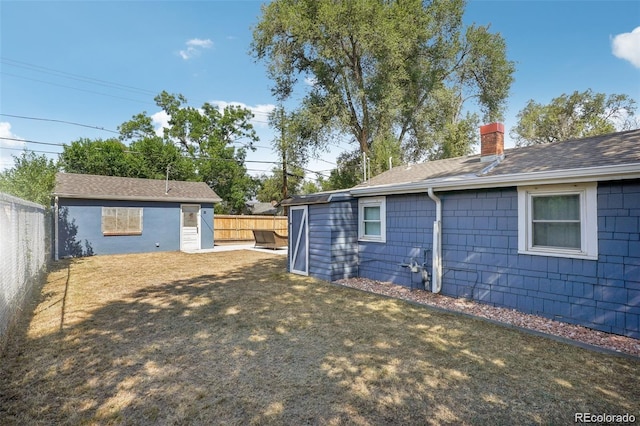 view of yard with an outbuilding and a fenced backyard